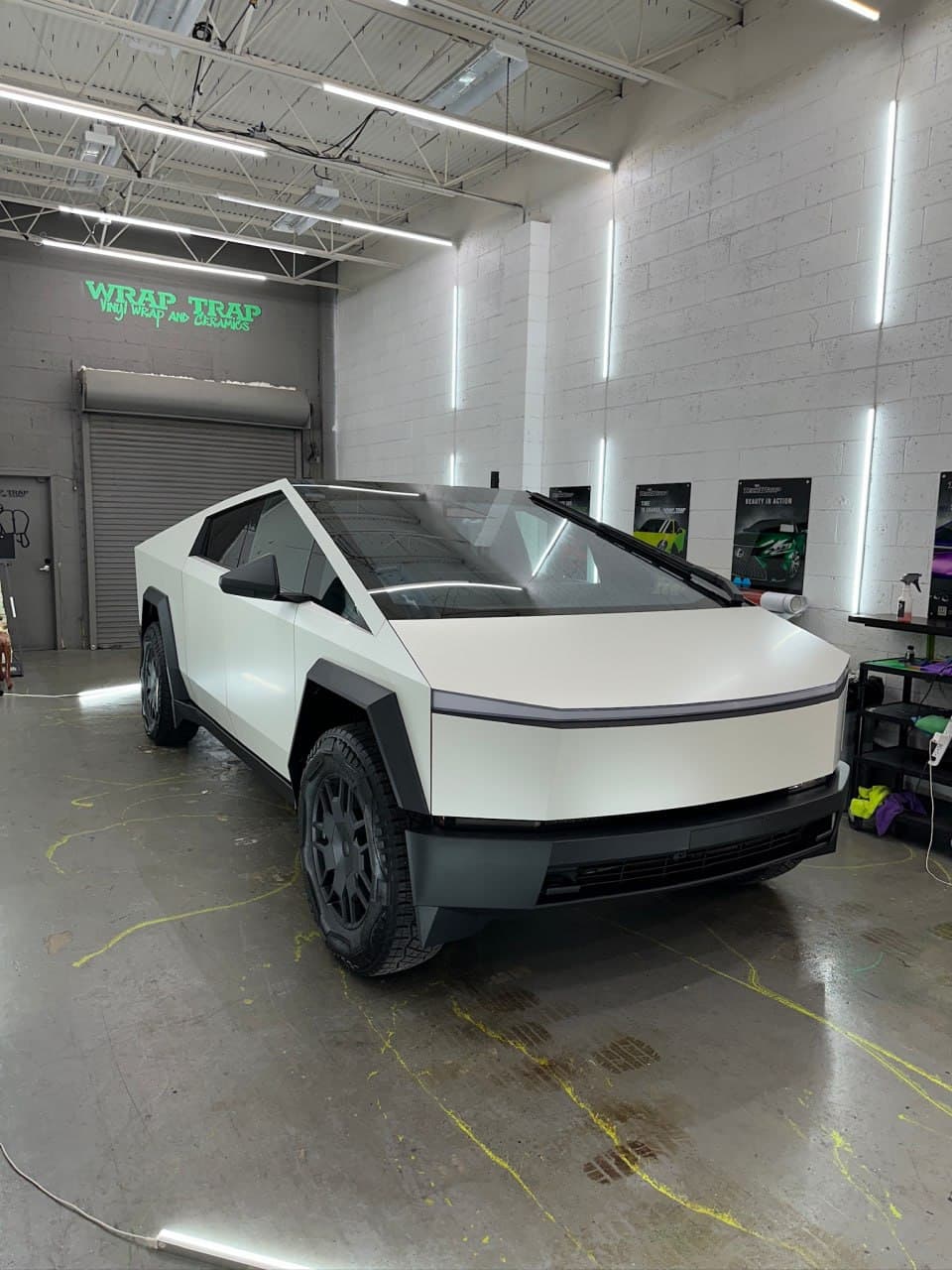 Tesla Cybertruck wrapped in 3M Satin Pearl White inside the Wrap Trap shop