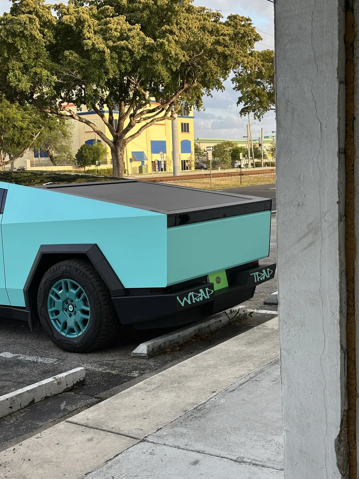 Tiffany Blue Tesla Cybertruck wrapped by Wrap Trap, rear quarter with Wrap Trap mud flaps