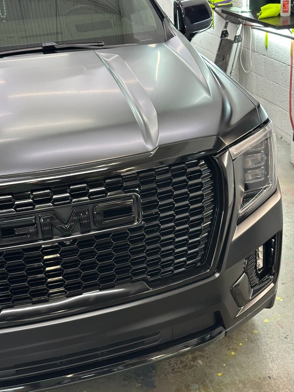 GMC Yukon in satin black vinyl wrap — a matte-specific ceramic keeps the finish flat